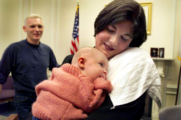Image: Lt. Gov. Jane Swift holds her baby, Elizabeth, at her office at the State House in Boston in 1999.