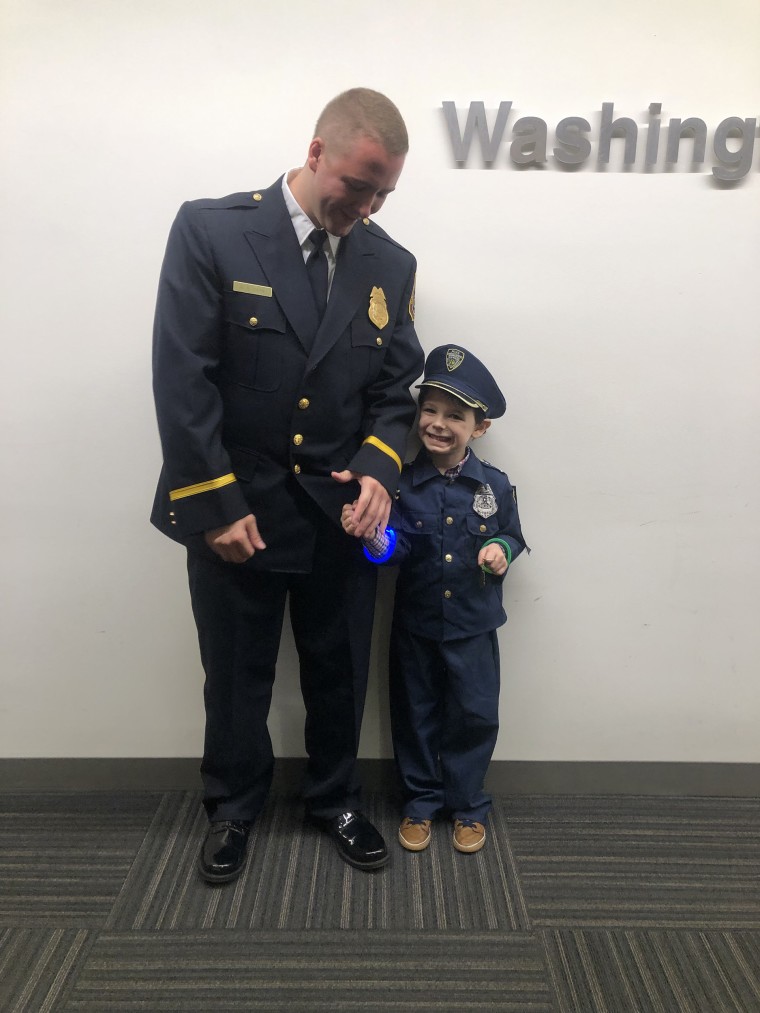 Metro Transit Police Officer Dominic Case with a 4-year-old boy named Andrew who has autism