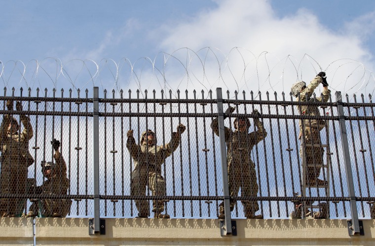Image: FILE PHOTO: FILE PHOTO: U.S. Army soldiers install a razor wire fence near the U.S-Mexico border in McAllen