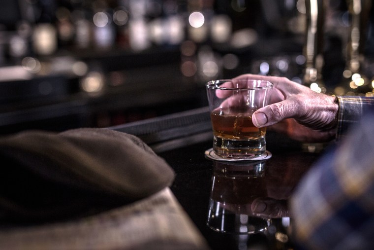 Image: Man drinking at bar