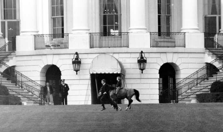 Caroline Kennedy rides her pony, Macaroni, on the south grounds of the White House