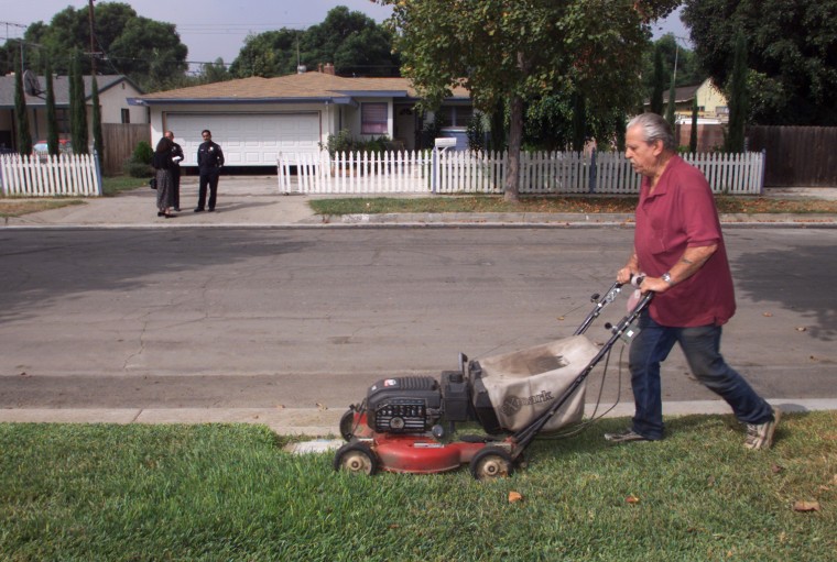 Image: Man mows layn in Santa Ana, CA