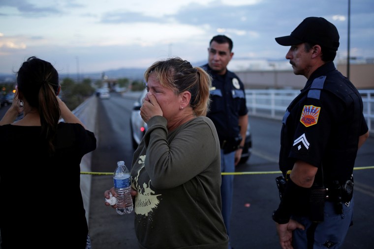 Image: A woman reacts after a mass shooting at a Walmart in El Paso