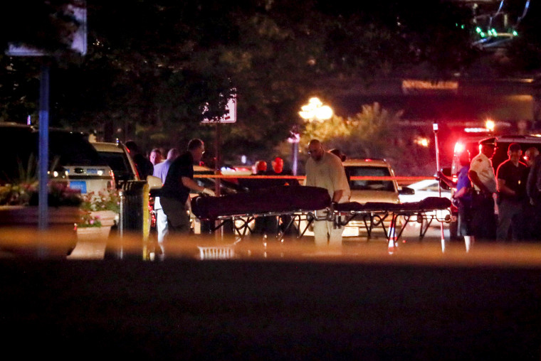 Image: Bodies are removed from the scene of a mass shooting in Dayton, Ohio, that left at least nine dead on Aug. 4, 2019.