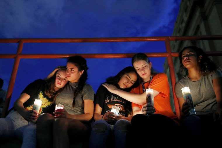 Image: Melody Stout, Hannah Payan, Aaliyah Alba, Sherie Gramlich and Laura Barrios comfort one another at a vigil for victims of a mass shooting in El Paso, Texas, that left at least 20 dead on Aug. 3, 2019.