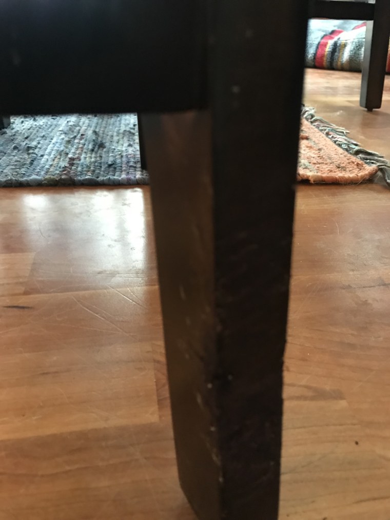 closeup of covered-up scratches and marks on dining room chair