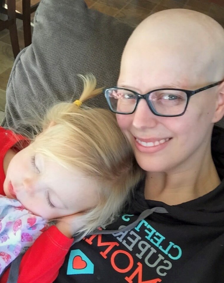 Brekka Schultz cuddling with her daughter while undergoing treatment for breast cancer.