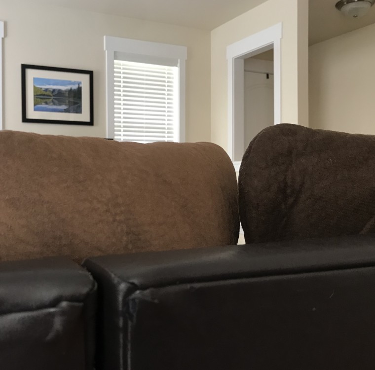 torn couch with tear no longer visible thanks to black furniture marker