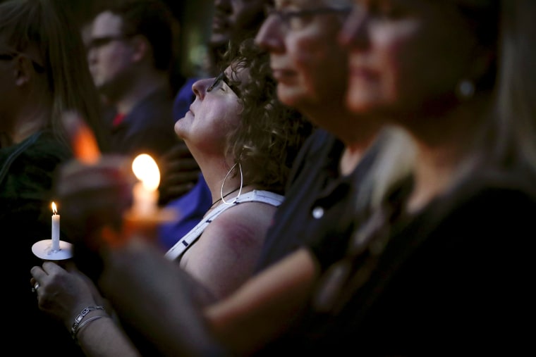 Image: Mourners attend a candlelight vigil after a mass shooting in Dayton, Ohio, on Aug. 4, 2019.