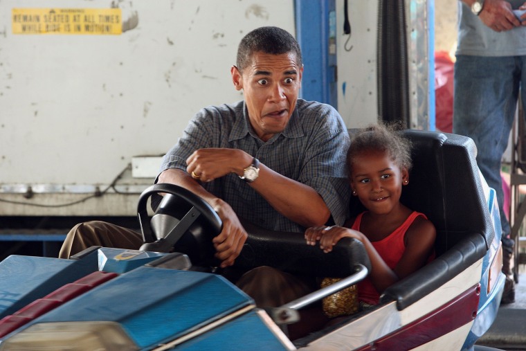 Image: Democratic Presidential Candidate Senator Barack Obama drives a bumper car with his daughter Sasha at the Iowa State Fair