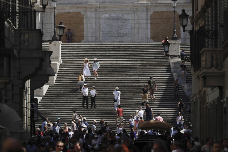 Image: People walk down the Spanish Steps in Rome