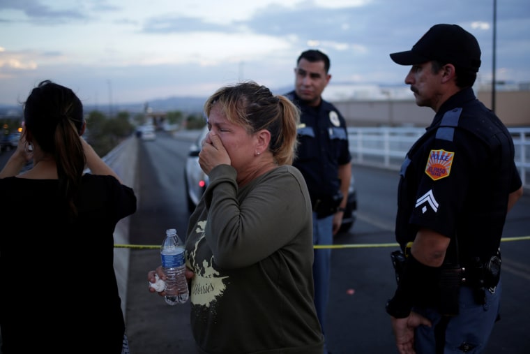 Image: A woman reacts after a mass shooting at a Walmart in El Paso