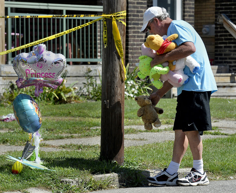 Image: Paul Laughlin leaves stuffed animals outside the scene of a house fire that left multiple people dead in Erie, Pennsylvania, on Aug. 11, 2019.