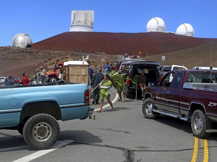 Protesters block vehicles from getting to the Thirty Meter Telescope groundbreaking ceremony site at Mauna Kea, Hawaii, on Oct. 7, 2014.