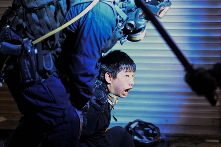 Image: A pro-democracy protester is held by police outside Tsim Sha Tsui Police station during a demonstration against the controversial extradition bill in Hong Kong