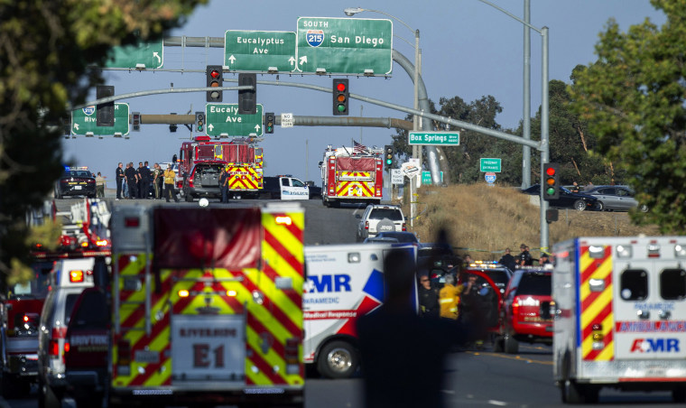 Image: Authorities work the scene where a shootout near a freeway killed a California Highway Patrol officer and wounded two others before the gunman was fatally shot,