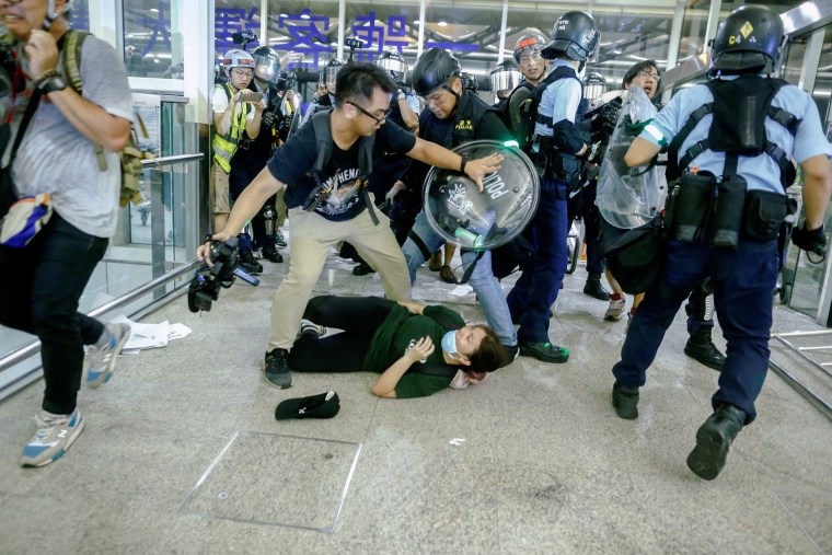Image: Riot police use pepper spray to disperse anti-extradition bill protesters during a mass demonstration after a woman was shot in the eye, at the Hong Kong international airport, in Hong Kong