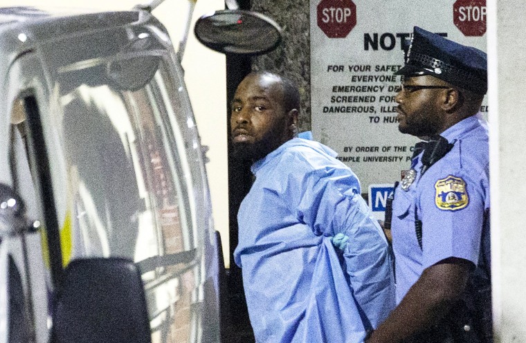 Image: Police escort shooting suspect Maurice Hill into custody after a standoff that injured several police officers in Philadelphia on Aug. 15, 2019.