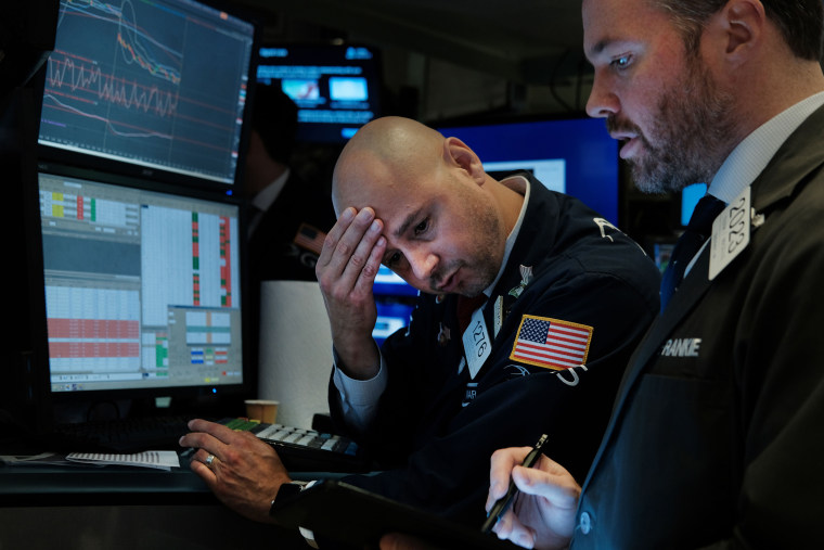 Traders work on the floor of the New York Stock Exchange on Aug. 14, 2019. Following news of an economic slowdown in both Germany and China, concerns over a recession in America sent stocks plummeting with the Dow down over 800 points.