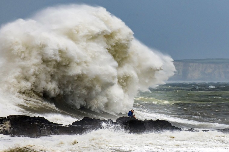 Waves crash against the harbor wall in Porthcawl, Wales. on Aug. 10, 2019. The Met Office have issued a yellow weather warnings for winds of up to 60mph and thunderstorms for large parts of the U.K.