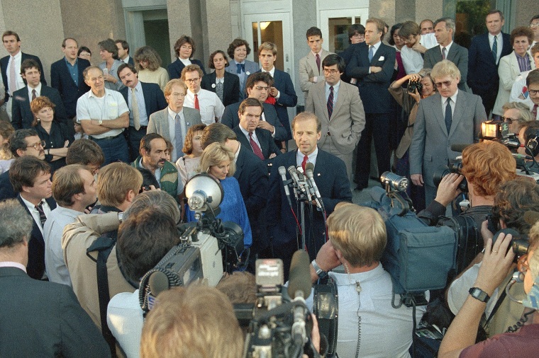 Sen. Joseph Biden tells reporters that he "will be back," as his staff of campaign workers listens on Sept. 24, 1987. After dropping out of the race, Biden returned to New Hampshire, the nation's first primary state, to thank his campaign workers. 