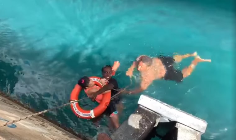 Two men rescued a women whose wheelchair rolled off a dock in the Virgin Islands.