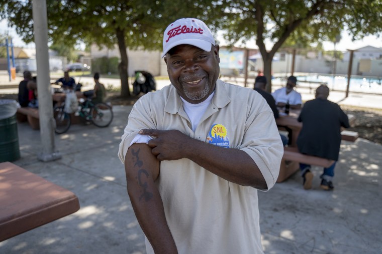 Larry Sanders displays a tattoo that police officers asked him to show when they stopped him on suspicions that he was a gang member.