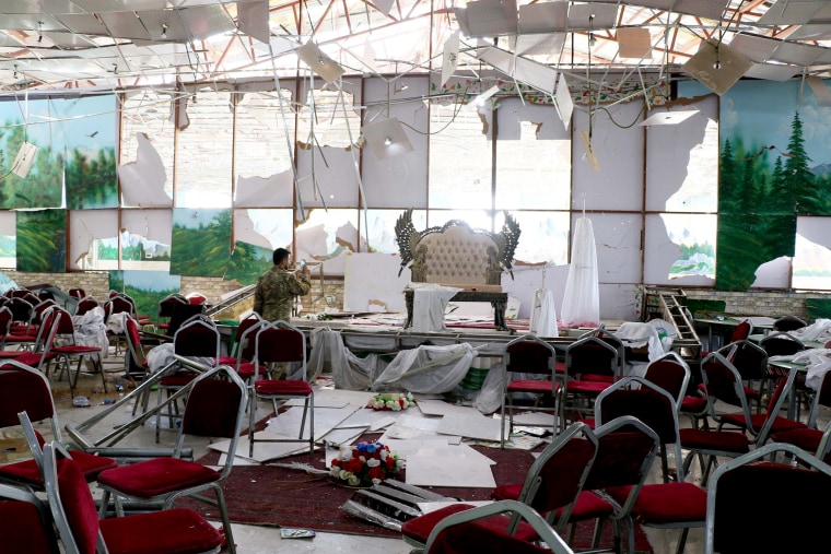 Image: Afghan security officials inspect the scene after a suicide bomb blast at a wedding reception in Kabul, Afghanistan, on Aug. 18, 2019.