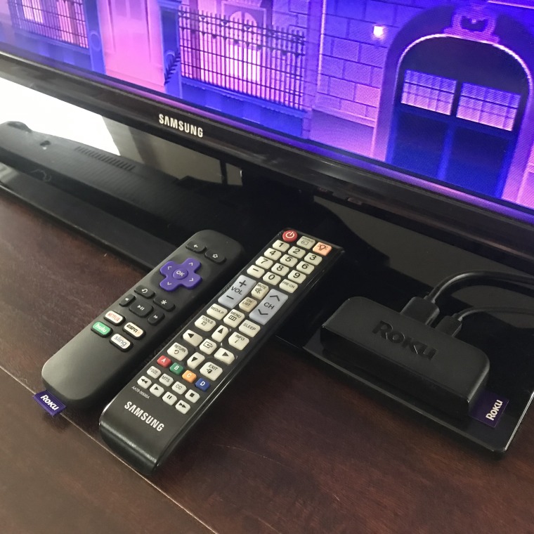 The ROKU Express remote and high speed HDMI cable plugged into my TV