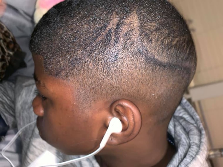 School administrators color boy's hair with marker