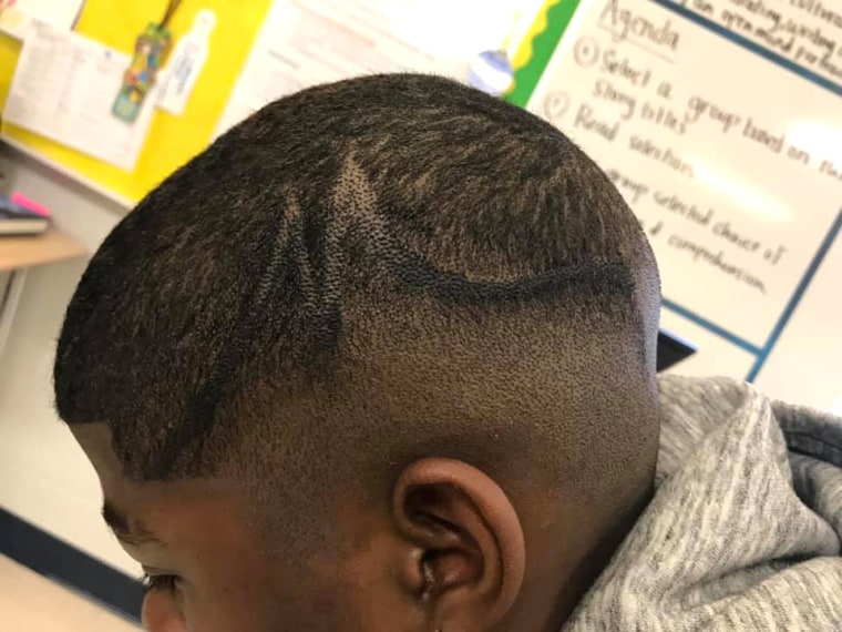School administrators color boy's hair with marker