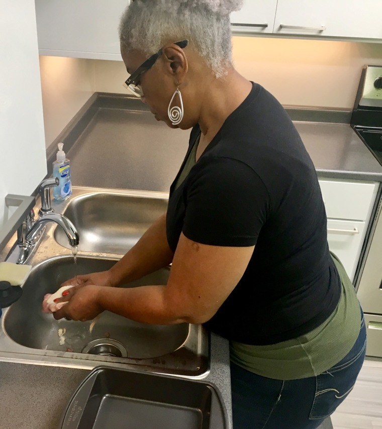 Image: Rita Ross rinses raw chicken in the sink to remove "slime" because that's how her mother used to do it. Food safety experts say the practice increases the risk for foodborne illness, even if the sink is sanitized afterward.