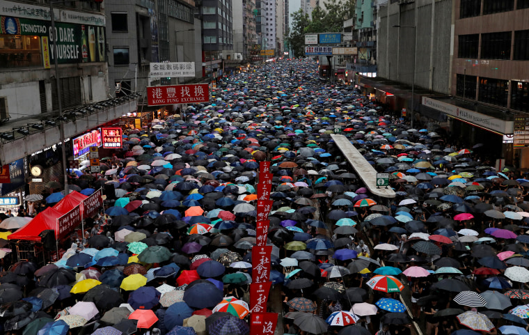 Image: People march during a rally to demand democracy and political reforms in Hong Kong