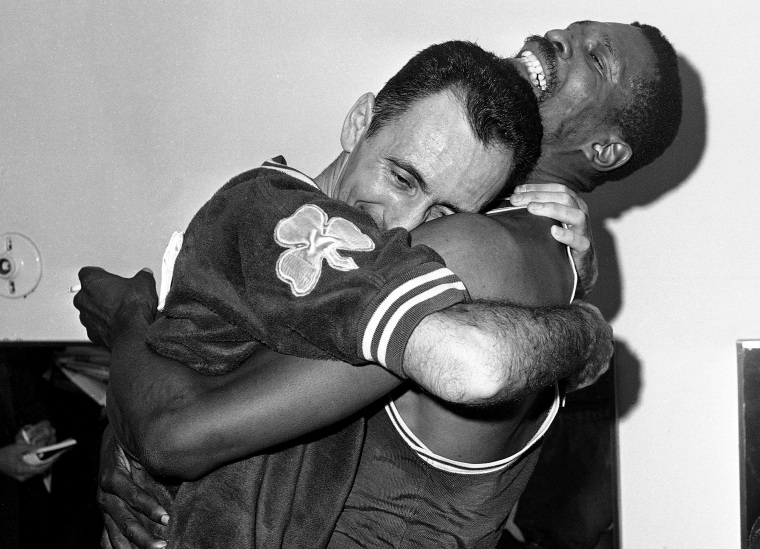 Image: Bob Cousy and Bill Russell share a hug after winning the Boston Celtics' fifth consecutive NBA Championship after defeating the Los Angeles Lakes in 1963.