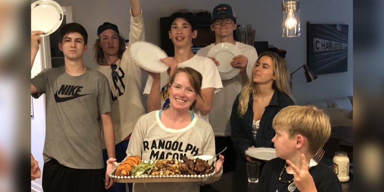 Jenn Folsom serves Friday night dinner to her three sons and their friends.