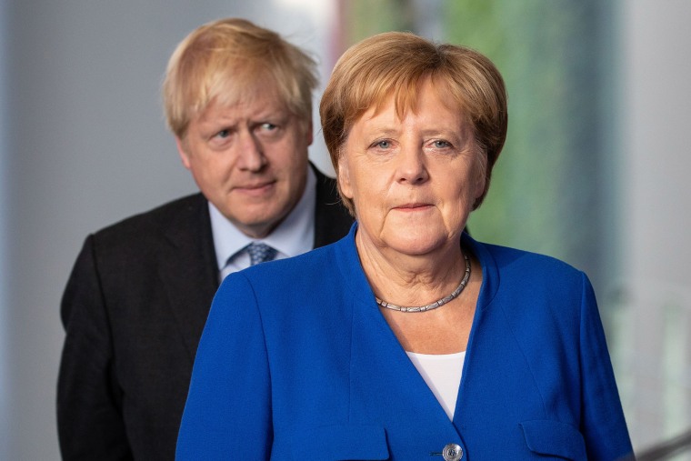 Image: British Prime Minister Boris Johnson and German Chancellor Angela Merkel attend a joint press conference following Johnson's arrival at the Chancellery