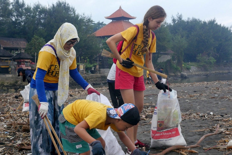 Image: Volunteers help pick up discarded plastic and rubbish on the beach in Denpasar, Bali.