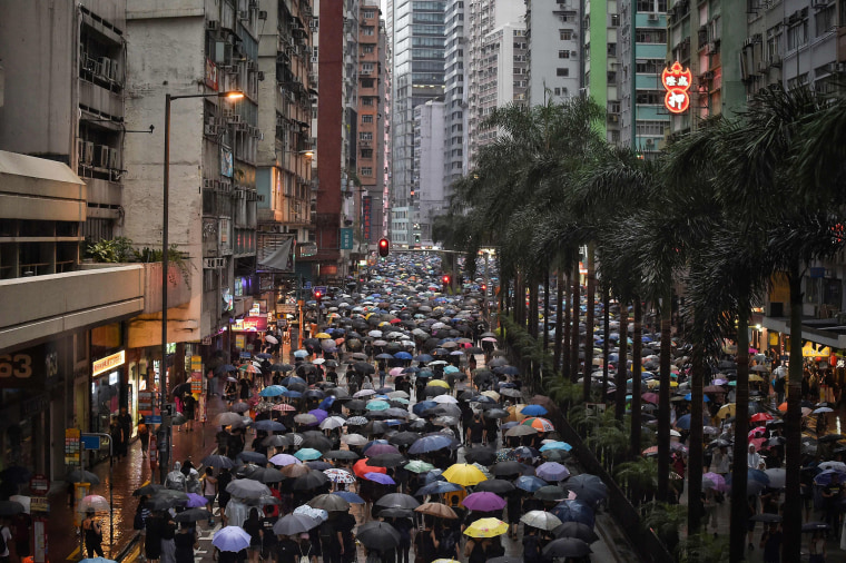 Image: Protesters walk along a street during a rally in Hong Kong on Aug. 18, 2019, in the latest opposition to a planned extradition law that has since morphed into a wider call for democratic rights in the semi-autonomous city.
