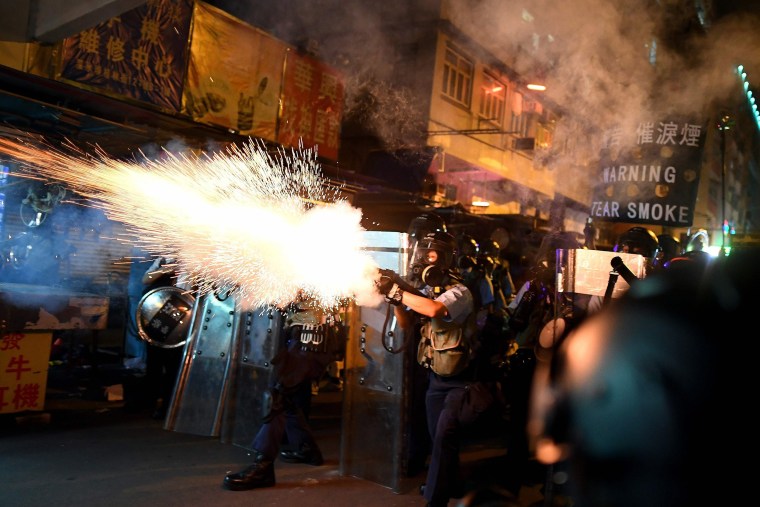 Image: Police personnel fire tear-gas shells to disperse Pro-Democracy protestors in the Sham Shui Po Area of Hong Kong