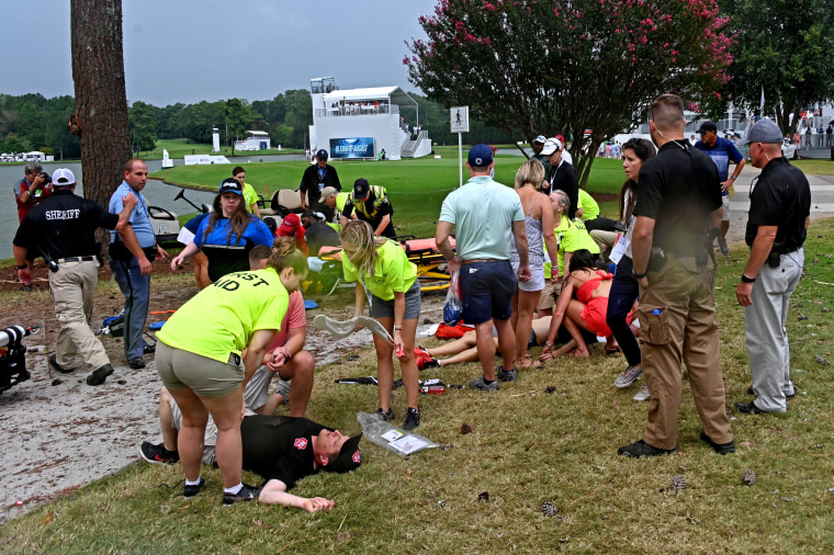 Medical personnel assist Billy Kramer (L) and others at the East Lake Golf Club after a lightning strike during the third round of the Tour Championship golf tournament.
