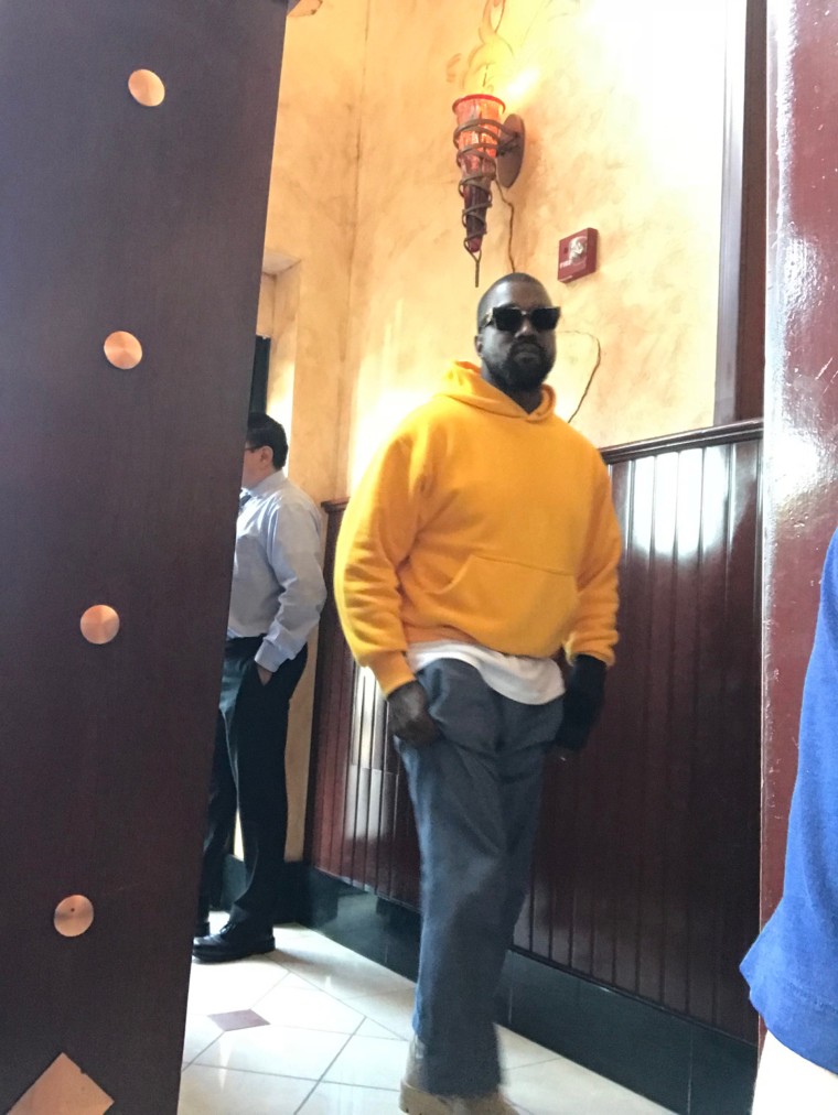 The rapper arrived to The Cheesecake Factory in a yellow hoodie.