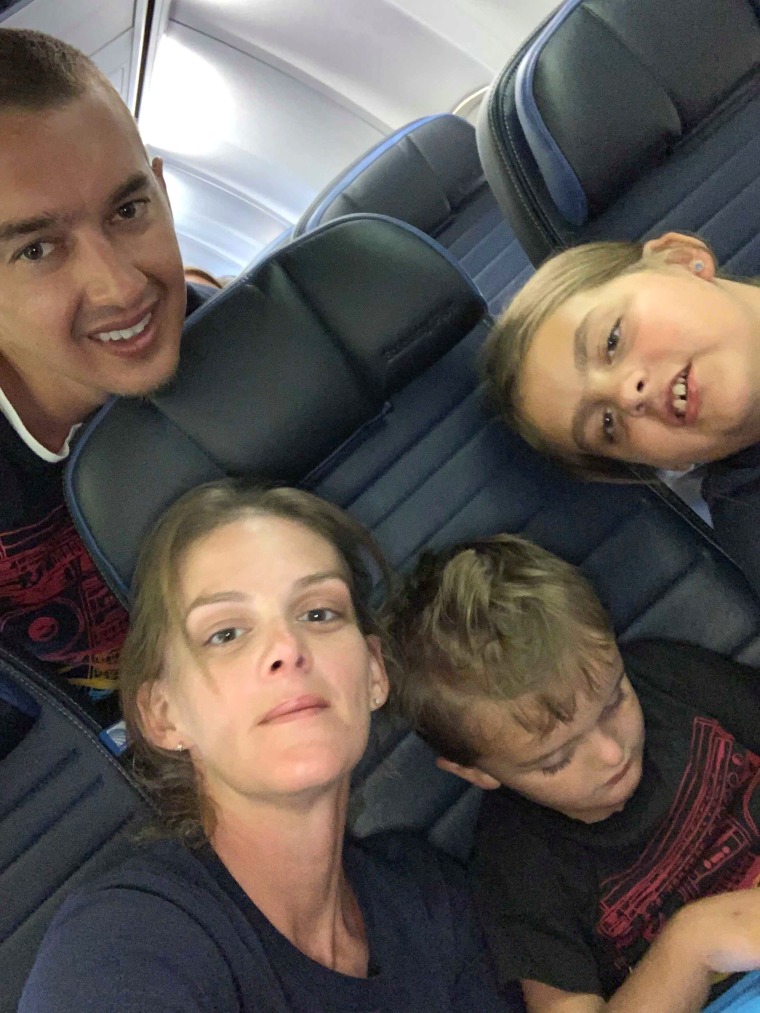 Passengers and crew help boy on airplane