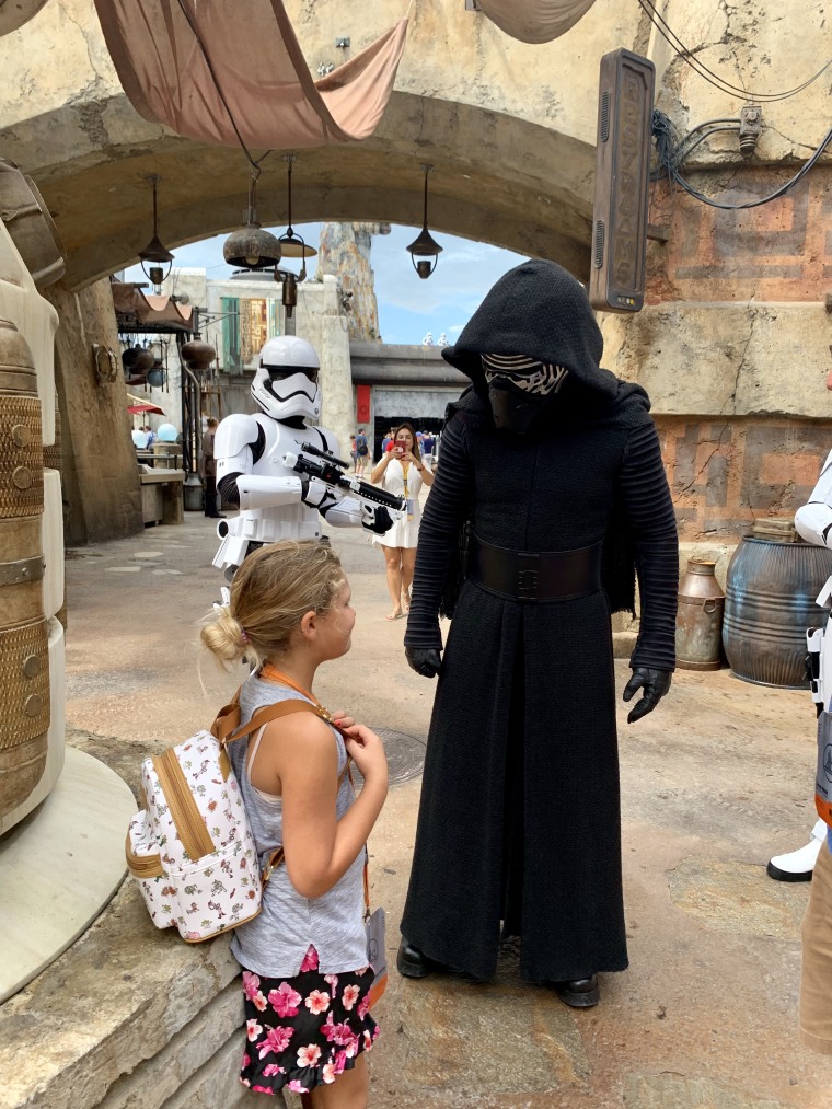 Just another day in Batuu: Kylo Ren checks in with my daughter about her allegiance to the First Order while a storm trooper looks on.