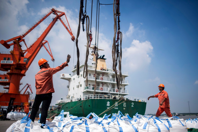 Image: Workers unload bags of chemicals at a port in China's eastern Jiangsu province on Aug. 7, 2018.