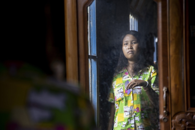 Lang Heang Khim, 22, brushes her hair at her home in the village of Chong Trek in the Kampong Cham province.