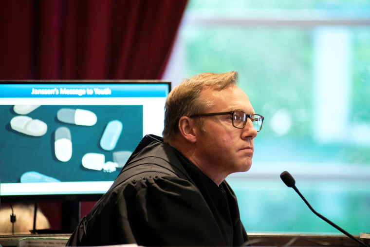 Judge Thad Balkman watches a video on the first day of a trial accusing Johnson &amp; Johnson of engaging in deceptive marketing that contributed to the national opioid epidemic in Norman