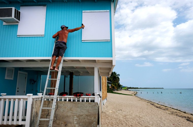 Image: A man boards up a house in Cabo Rojo as Tropical Storm Dorian approaches Puerto Rico, on Aug. 27, 2019.