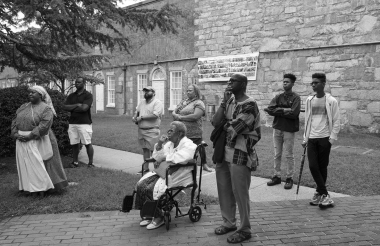 Image: Spectators watch as Joseph Rogers portrays his ancestor James Apostle Fields, in Hampton, Va.