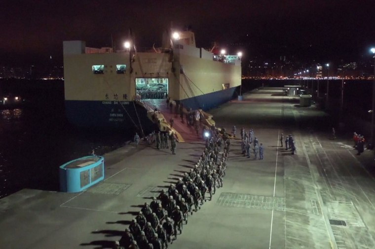 Image: People's Liberation Army (PLA) troops from the Hong Kong Garrison arriving on a ship in Hong Kong during a routine rotation of personnel