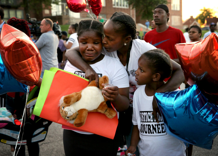 Image: Shardae Edmondson, 11, is consoled by her mother, Sharonda Edmondson, and sister Zha'lea Thompson, 7, during a vigil for murdered children in St. Louis held at Herzog Elementary School in the city Aug. 28, 2019. Shardae's and Zha'lea's sister Jurne